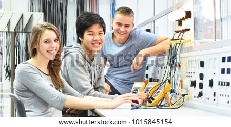 group of cheerful young students in vocational education and training for electronics