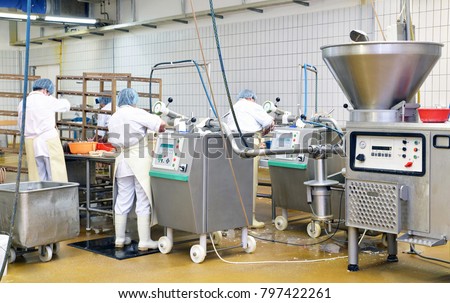 Workers in the production of original German bratwurst in a large meat processing plant in the food industry