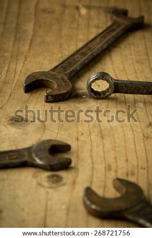 old vintage retro used open-end wrenches on wooden table