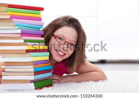 Young student with lots of books - happy and smiling