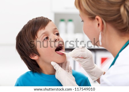 Say aaah - little boy at the physician checking his throat