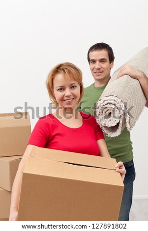 Couple moving into a new home - carrying stuff, closeup