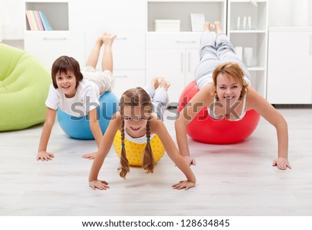 Happy people using large exercise balls - doing gymnastic at home