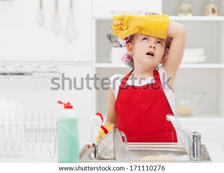 Little housekeeping fairy girl tired of home chores - doing the dishes
