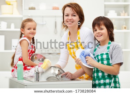 Kids helping their mother in the kitchen - washing the dishes together