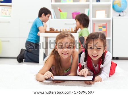 Kids playing classic board games versus modern tablet computer games