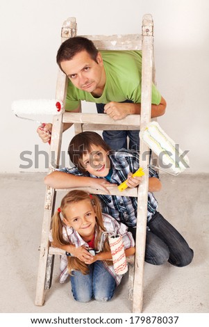 Ready for the paint job - father and kids with painting utensils