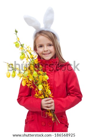 Little girl in spring clothes and flower branch decorated for easter - isolated