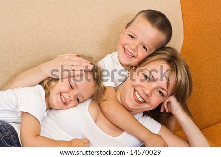 Woman laying on the sofa with her kids