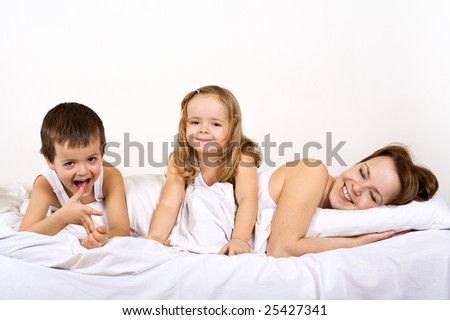 Woman and kids staying in bed in a lazy morning
