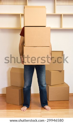 Man carrying lots of boxes - moving to a new home concept