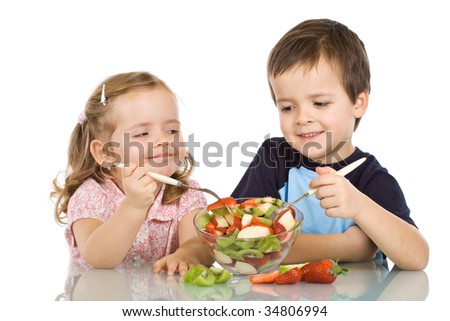 stock photo : Happy smiling kids eating fruit salad - isolated