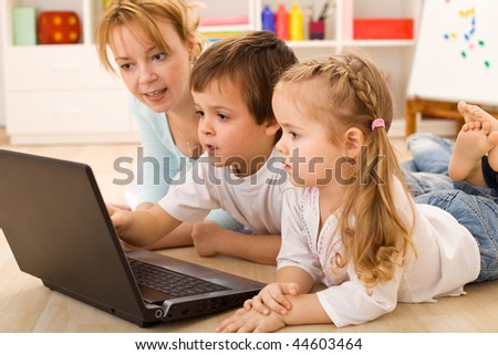 stock photo : Family online - kids learning the use of computers with their 