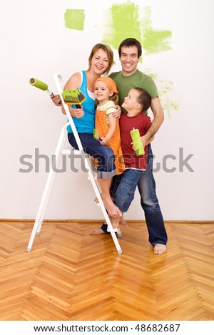 Happy family with painting utensils before redecorating their home