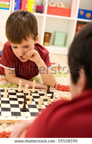 What should I do now - kid playing chess thinking hard biting his thumbnails