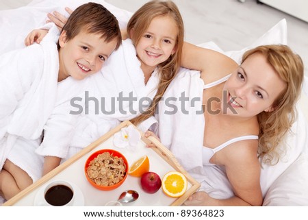 Breakfast in bed for mom-kids pampering their mother