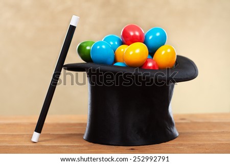 The magic of easter - colorful eggs in magician hats on golden background- shallow depth of field