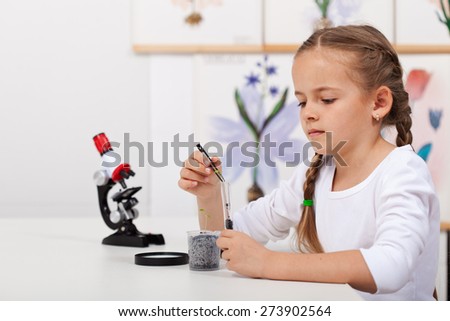 Young student in biology science class study small plants growth