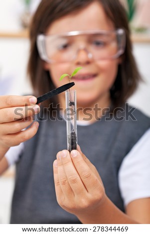 Young boy study plant evolution in science class - closeup, focus on plant