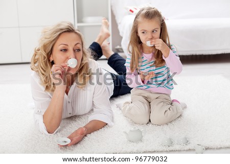 Would you care for a cup of tea - woman and little girl playing