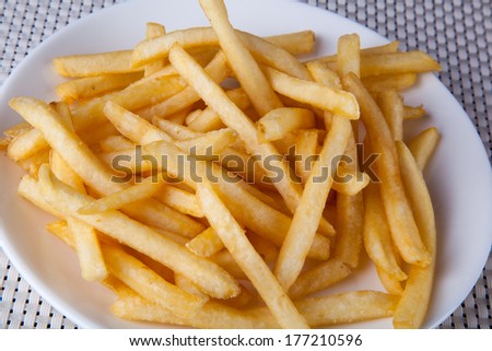 Close up of fried fast food french fries in white plate