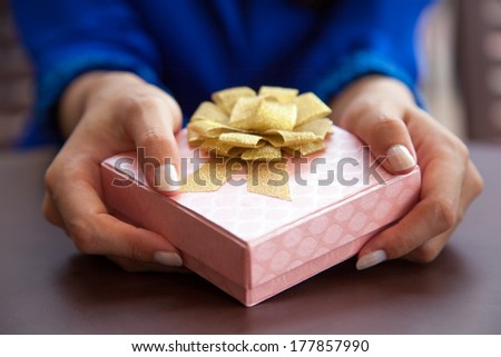 Woman giving gift box present