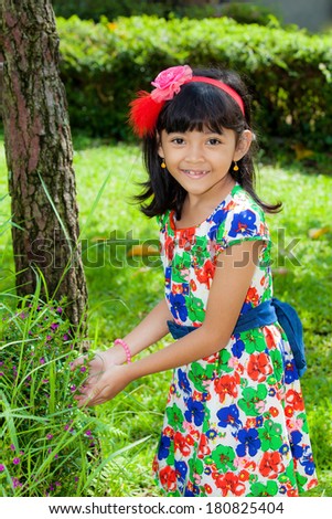 Pretty Asian Child holding small flower