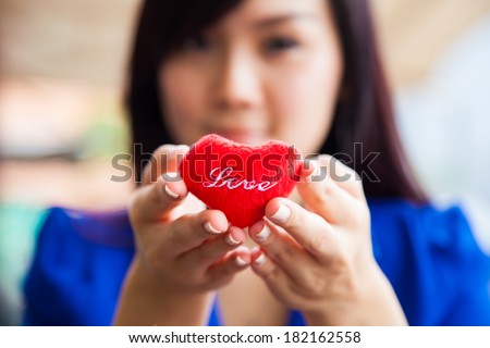 Asian Chinese Woman holding love shaped object