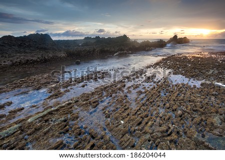 Sunset with coral texture at Sawarna Beach West Java Indonesia