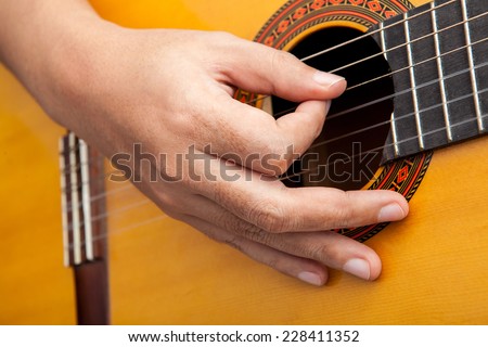 Hand playing musical instrument classic guitar
