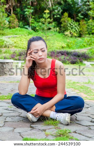 Asian Woman having bad headache during exercise