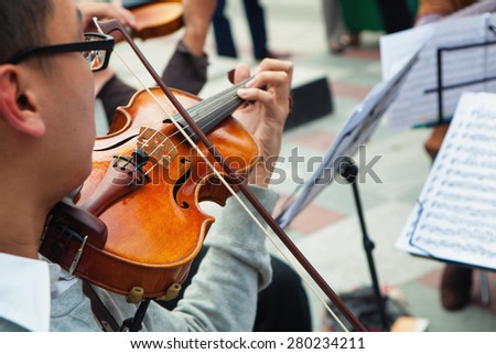 Musician playing violin instrument on the street