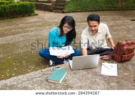 Student studying in university with books and computer