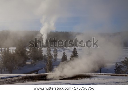 Yellowstone National Park in Winter, Wyoming USA - geysers and geothermal mineral pools with snow.
