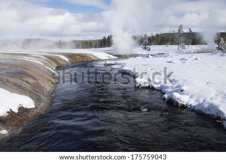 Yellowstone National Park in Winter, Wyoming USA - geysers geothermal mineral pools with snow around the Firehole River