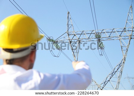 Male engineer standing at electricity station