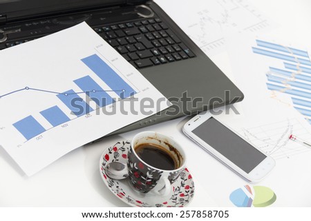 Businessman  with coffee and laptop analyzing of the  monitoring profit dynamics in the company
