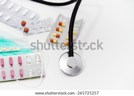 Set for flu treatment -  pills, thermometer, nasal sprays, protective surgical mask, stethoscope, syringe...