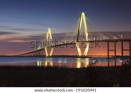 Ravenel Bridge in Charleston, South Carolina, illuminated against the night sky.