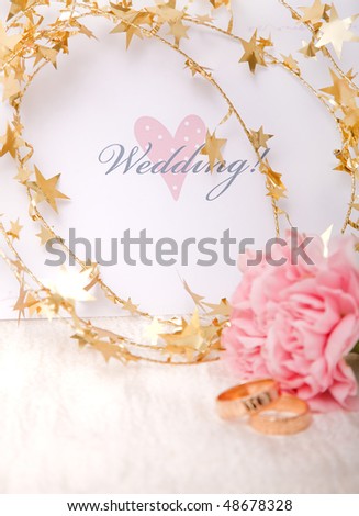 stock photo Wedding invitation with gold ribbon and rings