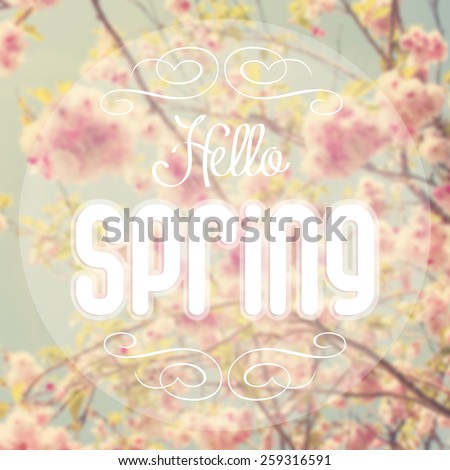 Hello spring text with out of focus spring background.