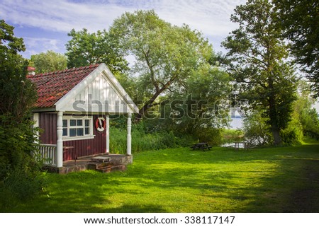 Image of a quaint red summer cottage. Rural Sweden.