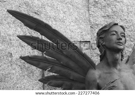 Sculpture of youth with wings. Black & white photo. Used material - metal.