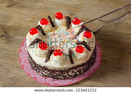 Cream cake on cutting  with plastic knife