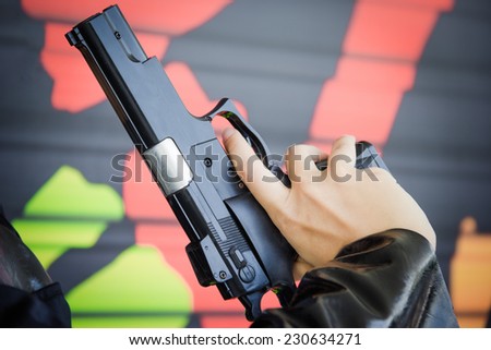 Black pistol in a hand