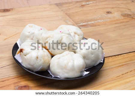 Chinese steamed buns  on wood background.