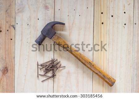 Hammer and nails on wood background