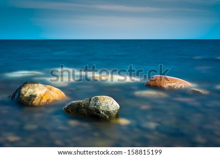 Three rocks in the calm water