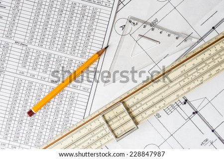 Schemes the pencil and triangle with slide rule on the table