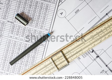 Drawing house plan, slide rule and pencil on the table